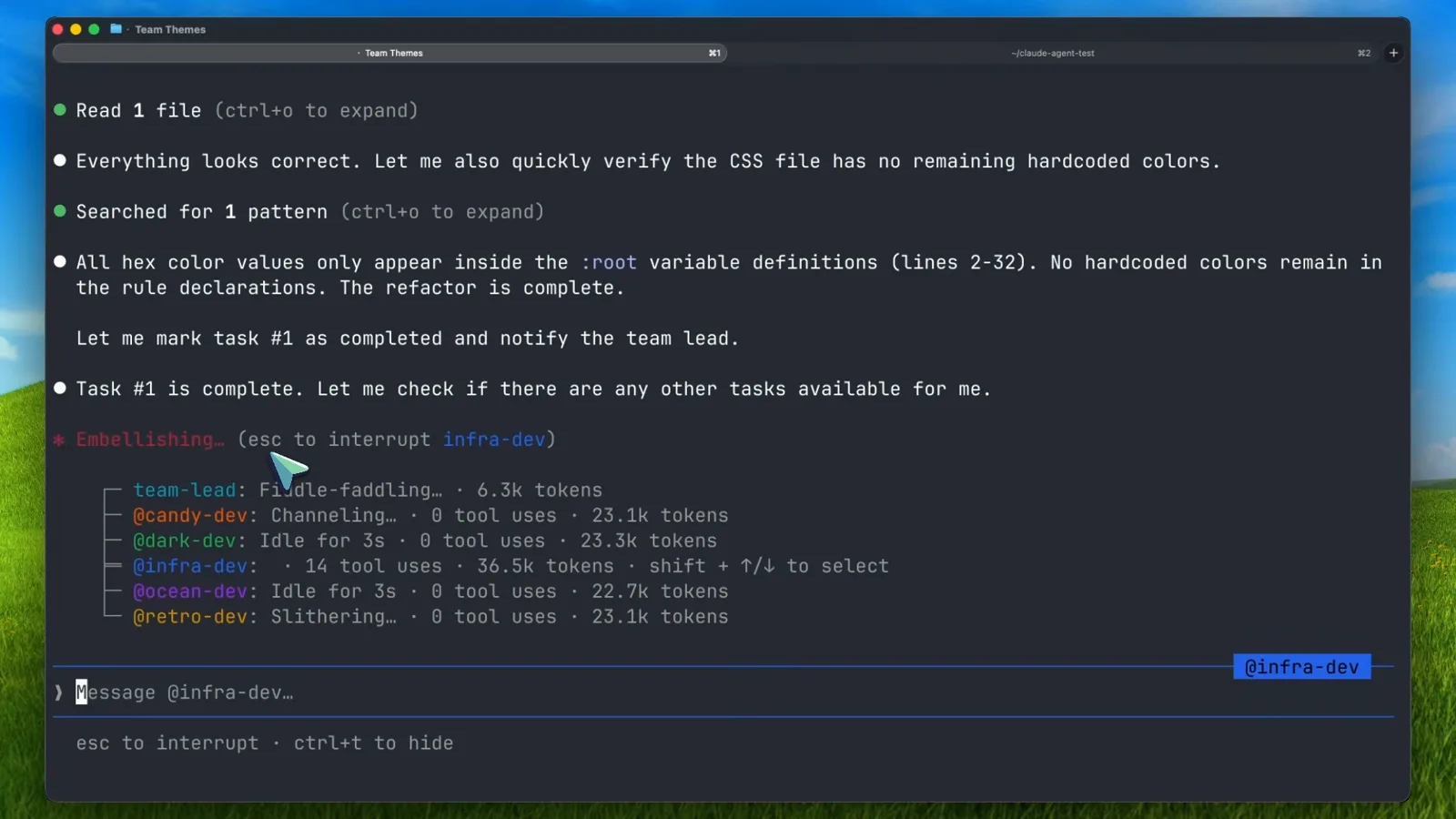 Claude Code teammates panel listing six named teammates with live token counts and shift+up and shift+down to select, while the message box addresses the infra-dev teammate directly with an @-mention